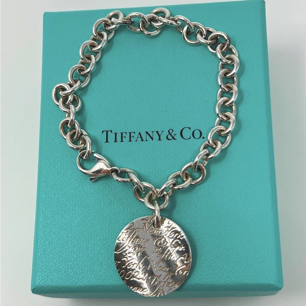Tiffany & Co Sterling Silver Notes Fifth Avenue Round Tag Link Bracelet. 7.25”